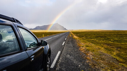 Road trip into the Snæfellsnes peninsula with rainbow in the background,  Iceland.