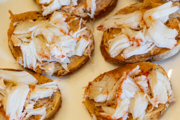 Blinis with lobster pieces