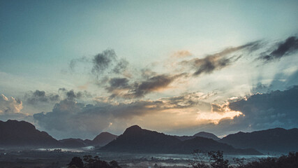 Morning view of mountain landscape with fog on sky and clouds background in Phatthalung province, Southern of Thailand.