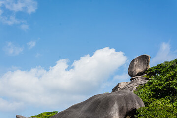Beautiful landscape people on rock is a symbol of Similan Islands, blue sky and cloud over the sea during summer at Mu Ko Similan National Park, Phang Nga province, Thailand