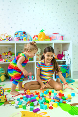 Children play together in the playroom. Selective focus.