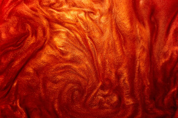 Defocus. Festive magical shimmering underwater luxury background. Abstract elegant, detailed particles of red glitter flow with a small depth of field underwater. Festive sparks and lights.