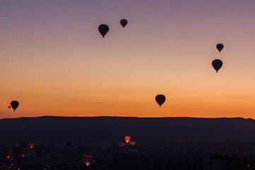 Early morning view of hot air balloons above Goreme village in Cappadocia, Turkey