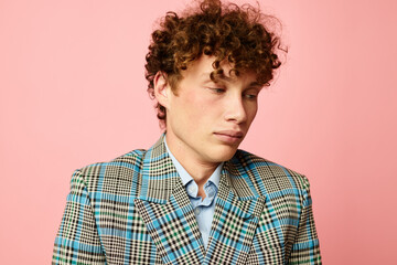 Young curly-haired man gesturing with his hands emotions checkered jacket Lifestyle unaltered