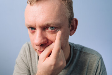 Fototapeta premium Contact lens into eye. Man put on to eye of contact lens