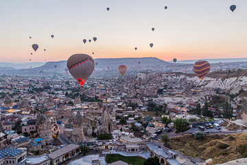 Early morning aerial view of hot air balloons above Goreme village in Cappadocia, Turkey