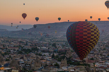 Early morning aerial view of hot air balloons above Goreme village in Cappadocia, Turkey