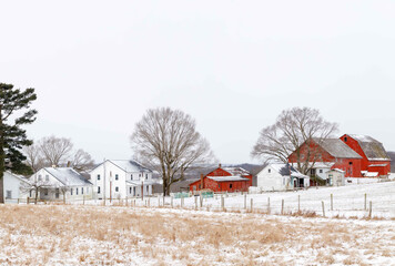 Amish Farm with Red Barns Nestled Among Snowy Fields in Ohio's Amish country