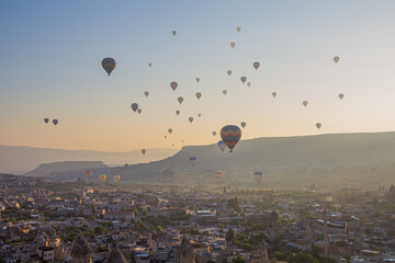 Fototapeta na wymiar Hot air balloons above Goreme town in Cappadocia, Turkey