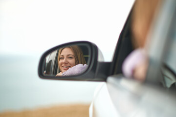 girl in mirror of car