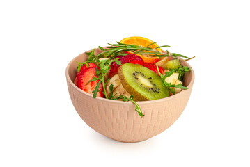 A bowl of fruit salad isolated on a white background. Healthy eating. Side view from the front.