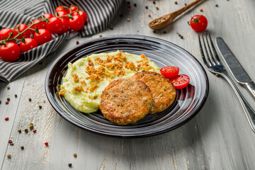Chicken cutlets with mashed potatoes on grey wooden table