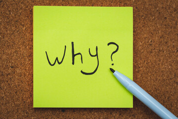 Why? written on a green note paper , Business Concept