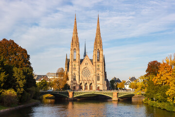 Fototapeta na wymiar Saint-Paul church at Ill river water Alsace in Strasbourg France