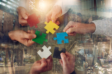 Teamwork of partners connect puzzle pieces as integration and startup