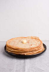A stack of delicious pancakes on a white background, Russian cuisine.