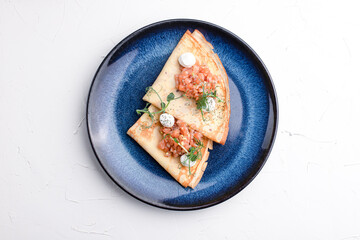 Pancakes with red fish, pancakes with fish on a white background, Russian cuisine