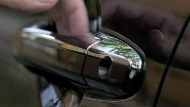 Close up of female hand opening a car door. Driver opens the driver's seat door and closes the door. Success and lifestyle. Close-up Slow motion