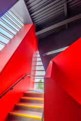 Staircase painted in red. Abstract fragment of the architecture of modern lobby, hallway of the luxury hotel, shopping mall, business center in Vancouver, Canada. Interior design.