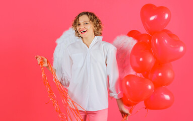 Woman cupid with white wings. Valentine angel with heart shape balloons. Valentines Day celebration.