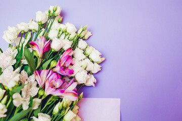 Spring flowers. Women's day purple background. Bouquet of white and pink eustoma. Present gift for Mother's day. Space