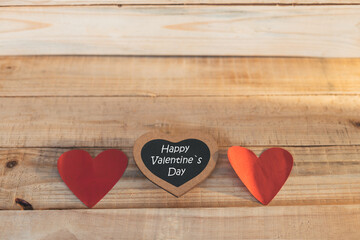 wooden blocks with red hearts and blackboard, Happy Valentine's Day, on wooden background