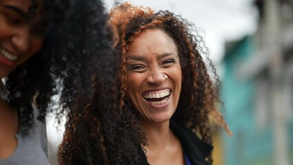 A happy black woman laughing and smiling a casual hispanic 40s lady real life laugh and smile - Powered by Adobe