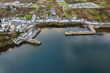 Aerial drone view on fishing town Roundstone in county Galway, Ireland located on Wild Atlantic Way route. Tourism and fishing industry. Beautiful Connemara nature scenery.