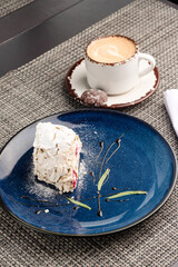 Dessert in the hands, dessert in a plate in the hands of a person, layered dessert