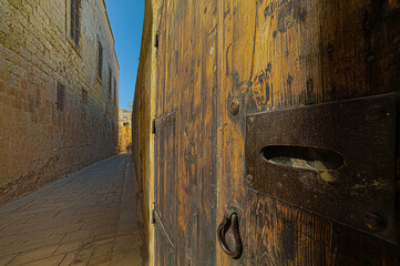 An old medieval wooden door in one of the streets of Mdina in Malta