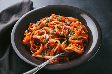 High angle view of spaghetti with tomato sauce on black background
