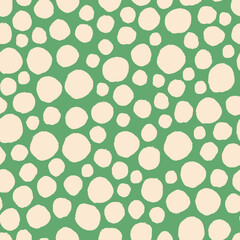 Hand drawn vector seamless pattern, abstract shapes. Circles, dots randomly scattered repeating elements. Green background for design.