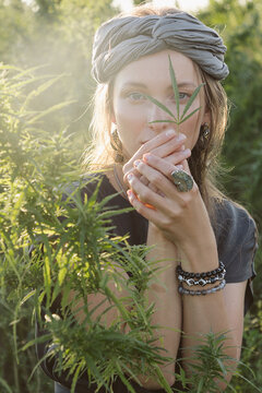 Woman in the Cannabis plant, Girl standing with Marijuana or Hem