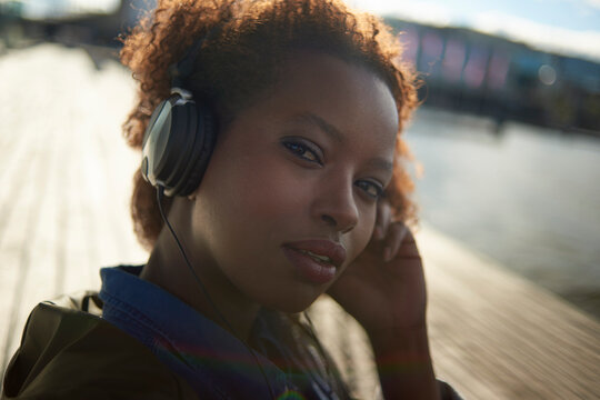 Portrait of a young black female with big afro hair wearing headphones