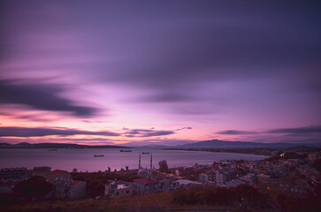 Long exposure,  clouds over the city aliaga at sunset time
