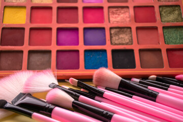 pink makeup brushes with colored backgrounds