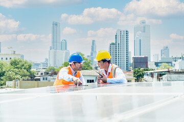A technician or electrical engineer is teaching an apprentice to work. An engineer or technician is checking the operation of the solar panel.
