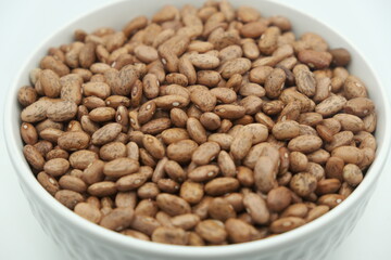 Brown beans in a white bowl