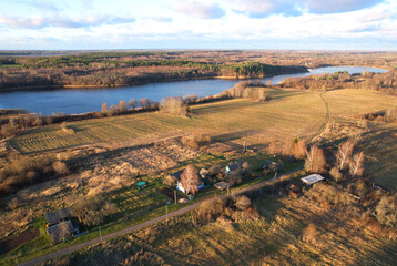 Wooden home in village at lake. Country houses in countryside.  Suburban house at countryside...