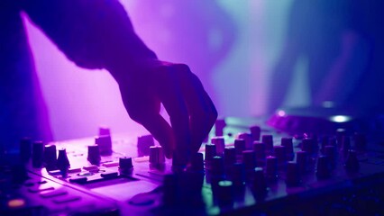 Close up of DJ hands moving controls on mixing desk at disco party. Nightlife, modern music and entertainment concept.
