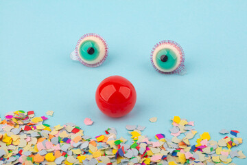Fototapeta na wymiar Red Nose and big Eyes with confetti