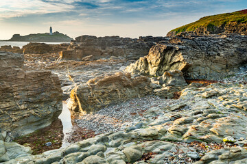 Godrevy Head and lighthouse,mudstone formations and seawater rockpools,North Cornwall,England,UK.