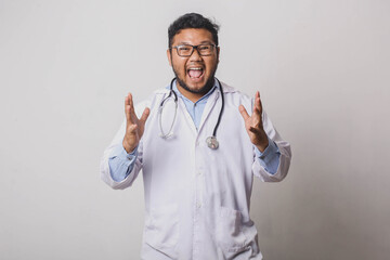 Happy male doctor with shocked screaming gesture isolated on white background