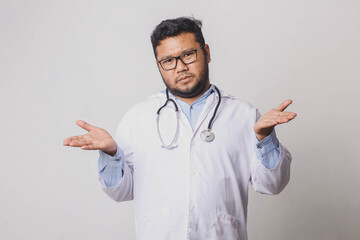 Male doctor with confused and indifferent expression isolated on white background