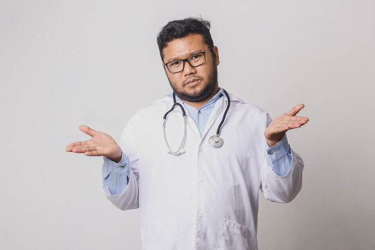 Male Doctor With Confused And Indifferent Expression Isolated On White Background