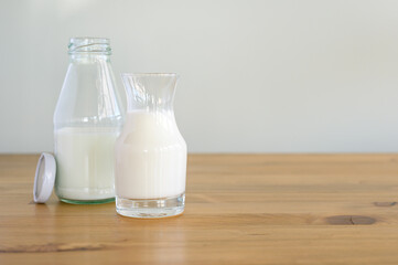 fresh milk in glass and Bottle on wooden table, healthy food and drink concept, Dairy products