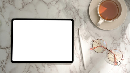 Feminine office desk with tablet blank screen mockup on marble background.