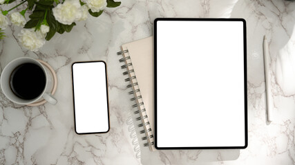 Modern female office desk with tablet, smartphone blank display on marble background.