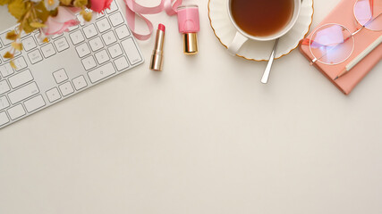 Top view of a beautiful feminine workspace with copy space on white background.