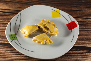 Meat pie in pieces on a plate